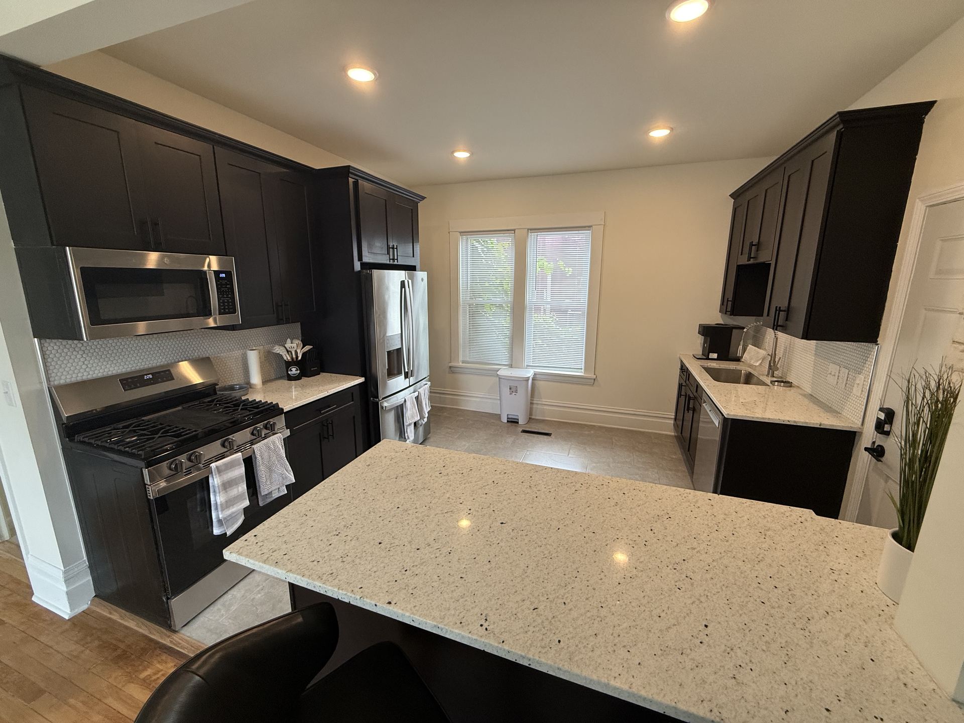 Kitchen with dark cabinetry and dining nook
