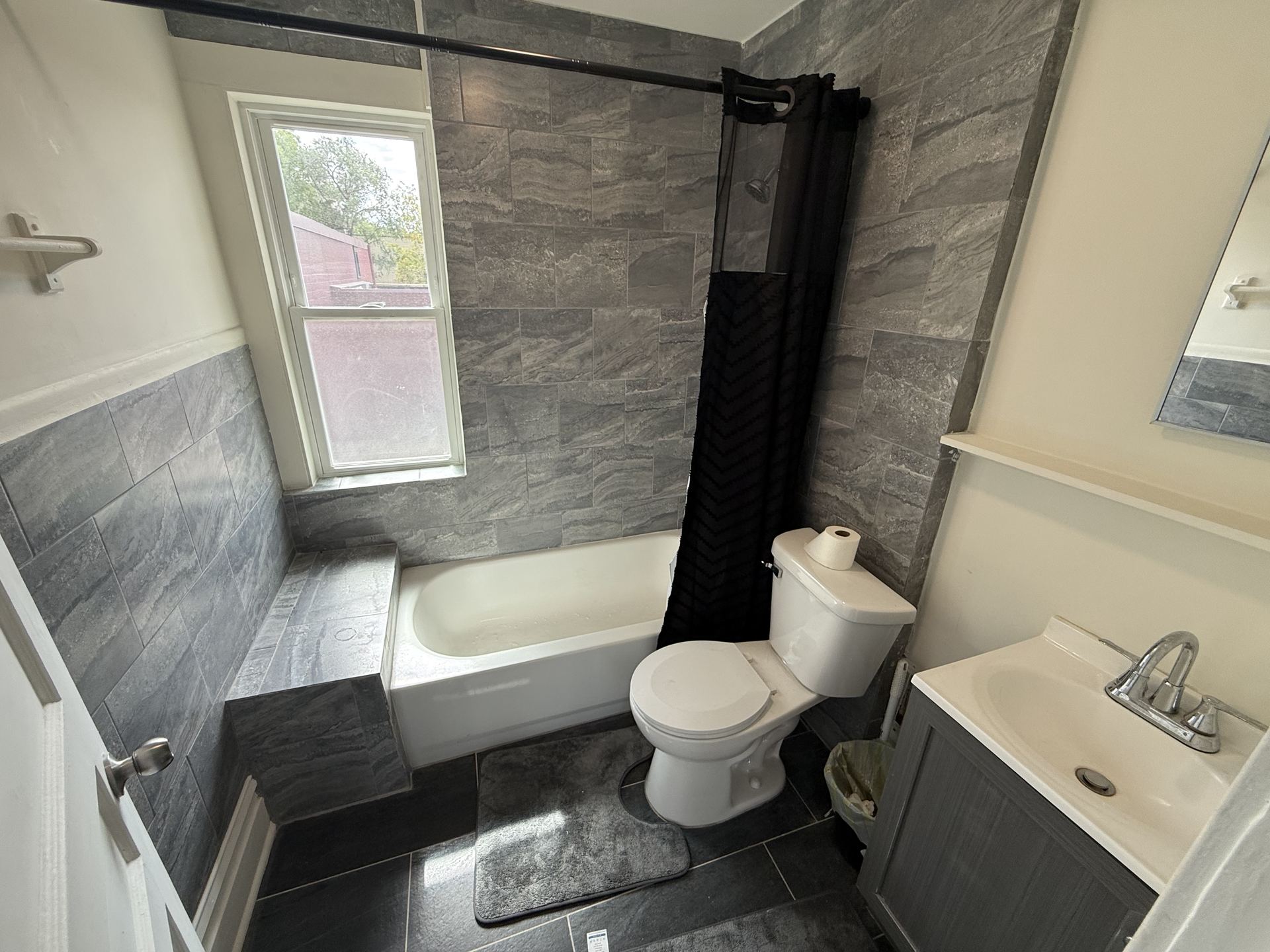 Bathroom with tiled tub and shower